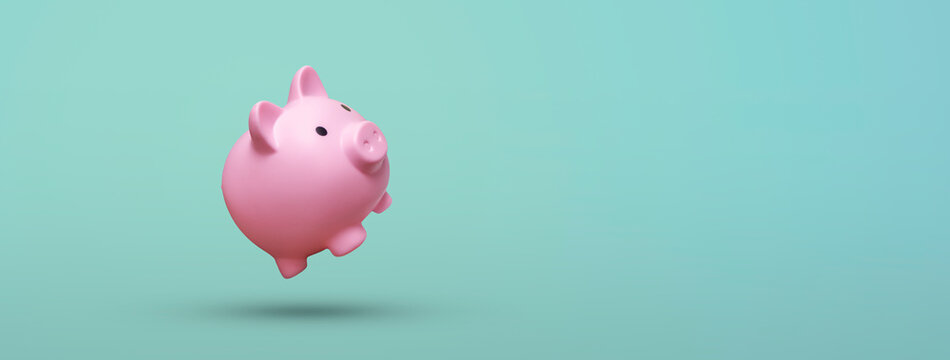 Pink piggy bank floating on blue background - savings concept