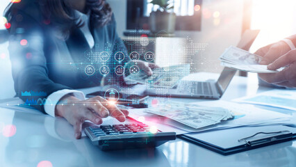 Woman accountant use calculator to calculate the company's financial results with icon banking on...