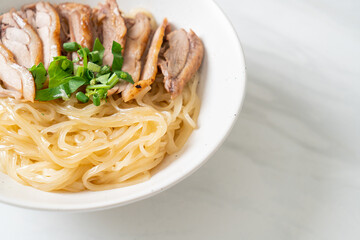 dried noodles with stewed duck in white bowl
