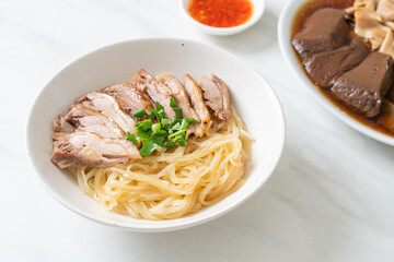dried noodles with stewed duck in white bowl