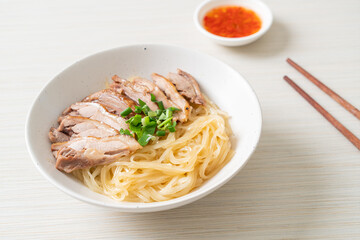 dried noodles with stewed duck in white bowl
