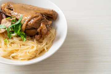 dried noodles with braised duck in white bowl