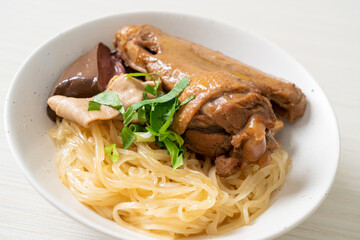 dried noodles with braised duck in white bowl