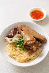 dried noodles with braised duck in white bowl