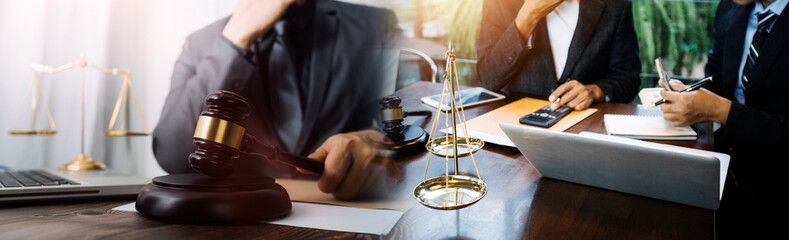 Business and lawyers discussing contract papers with brass scale on desk in office. Law, legal services, advice, justice and law concept picture with film grain effect
