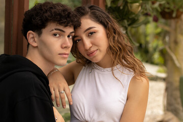 Young Latino model couple from Costa Rica on a winter day. Looking at each other and caressing each other.