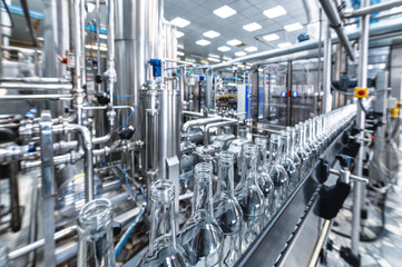 Row of glass bottles to fill with expensive alcohol drinks