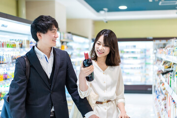 Young couple buying wine at a store