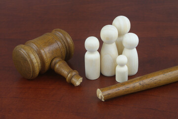 Injustice and family laws concept. Family people figures and broken judge gavel on wooden...