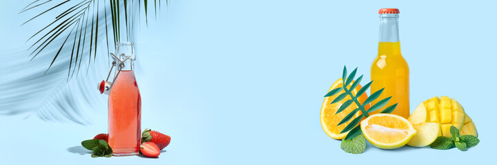 Bottle of tasty soda and fruits on blue background