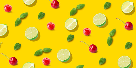 Limes, cherries and mint on yellow background. Pattern for design