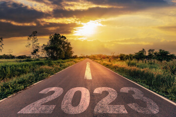 Empty asphalt road and New year 2023 concept. Driving on an empty road to Goals 2023 with sunset. - 512244092