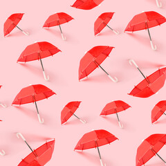 Many red umbrellas on pink background. Pattern for design