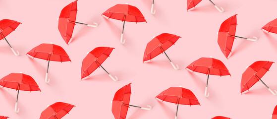 Many red umbrellas on pink background. Pattern for design - obrazy, fototapety, plakaty