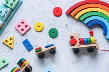 Toy train with building blocks on light background