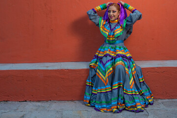 Fototapeta na wymiar Young Mexican woman prepares her dress and makeup for a traditional Mexican dance