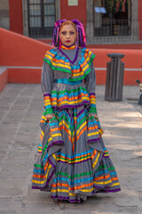 Portrait of a Mexican woman wearing a traditional dress for folk dance