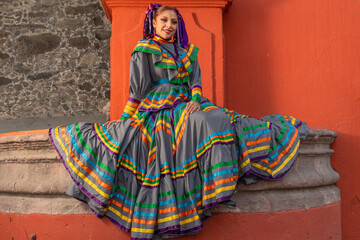 Portrait of a Mexican woman wearing a traditional dress for folk dance