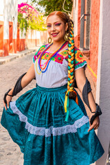 Portrait of a Mexican woman wearing a traditional dress for folk dance