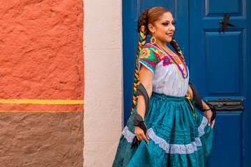 Portrait of a Mexican woman wearing a traditional dress for folk dance