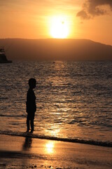 Beautiful view of sunrise on the beach with silhouettes people on the waterfront. Great for Background. 