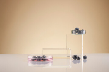 Front view of blueberry extract decorated with transparent podium and glassware blank space in brown background	