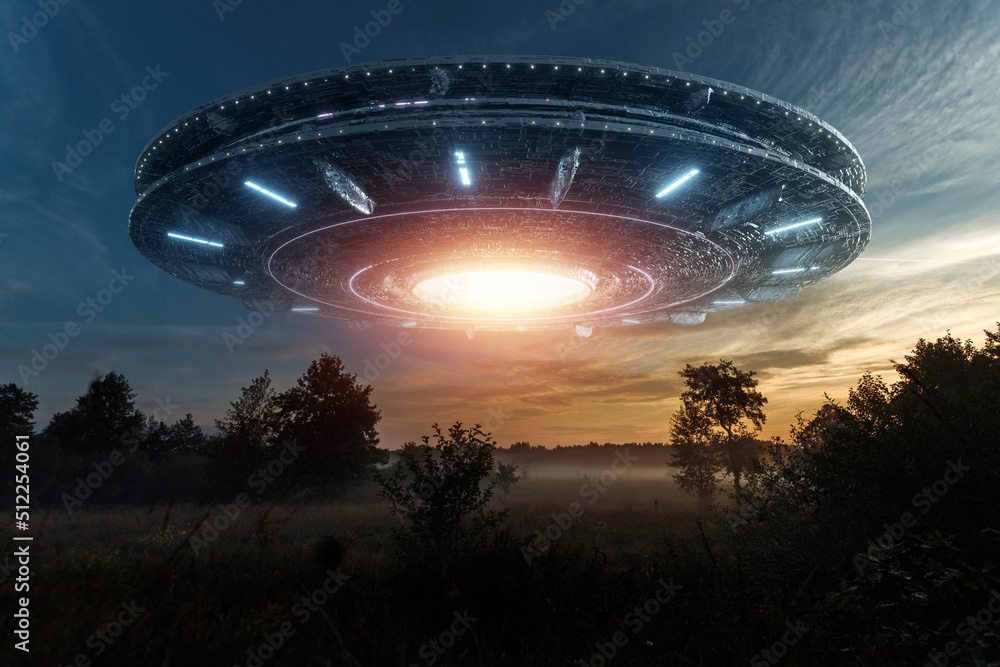 Wall mural ufo, an alien saucer hovering above the field in the clouds, hovering motionless in the sky. unident