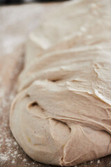 The process of making wheat bread at home. Dough division. The concept of healthy homemade food. Vertical photo.