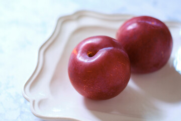 プラム、皿、大理石背景