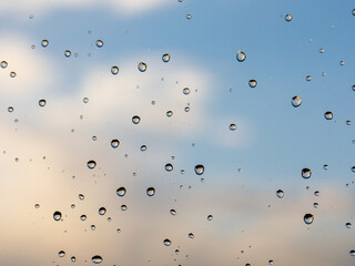 raindrops on glass sunset sky texture. Pure blue fresh clean. Window view background screensaver....