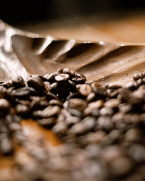 A close up picture of coffee beans in plate, picture is clicked by selected focus 