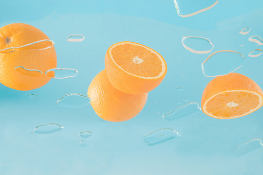 Creative summer concept with oranges on glass for a party or picnic. Bottom view.
