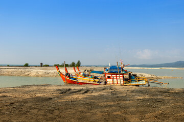 Thai style wooden fishing boats at the dead coral flats beach in Phang nga, Thailand, travel industry in south of Thailand, summer outdoor day light