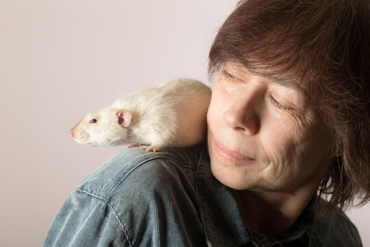 woman with a white domestic rat closeup