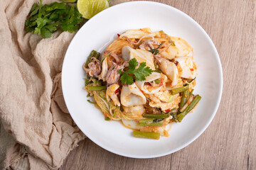 Sukiyaki dried squid Thai food in white bowl on wooden background