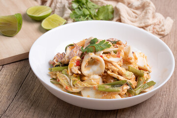 Sukiyaki dried squid Thai food in white bowl on wooden background