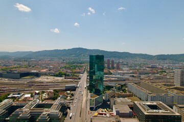 Fototapeta premium Aerial view of City of Zürich with skyscraper and main road with Hard Bridge at industrial district on a sunny summer day. Photo taken June 20th, 2022, Zurich, Switzerland.