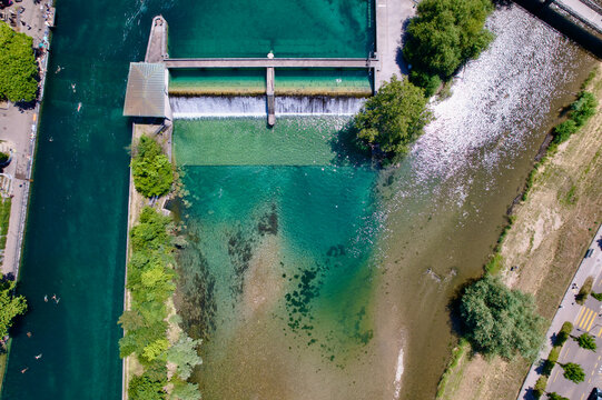Junction of Limmat River and Sihl River at Platzspitz with flood control at City of Z&uuml;rich with swimmers and people sunbathing on a sunny summer day. Photo taken June 20th, 2022, Zurich, Switzerland.