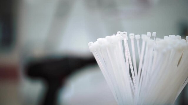 male hand takes a plastic clip, wire tie. High quality FullHD footage