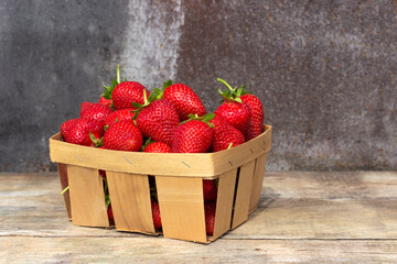 Fresh strawberries in the box on wooden vintage table