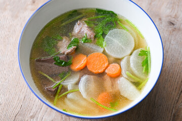 Menu healthy food , clear soup bowl with pork ribs pig pork blood vegetable and celery , Daikon radishes and carrot soup