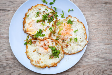 Menu healthy food in the moring ,  healthy breakfast fried eggs on plate with coriander and sauce food fried egg - top view