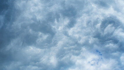 Gray clouds covered the blue sky. Dirty heavy clouds. A change in the weather. Background image.