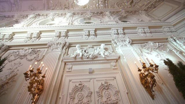 Decorative item made of white plaster on ceiling and wall. Beautiful ornament and relief stucco interior. High quality FullHD footage
