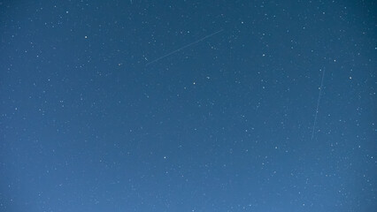 Starry sky with traces of passing meteorites. Night sky with stars. Background image.