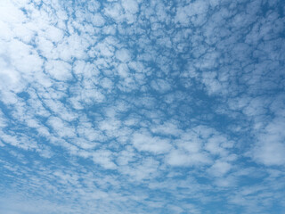 Deep blue skies with white clouds background with space for text, blue cloudy skies texture. front...