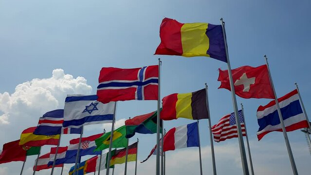 International colorful national flags sway in outdoor wind abstract of world collaboration slow motion