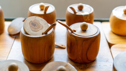 Wooden cups, spoons and glass lids made of wood. Cutting board of wood. Traditional cup with nature concept. Wooden drink set.