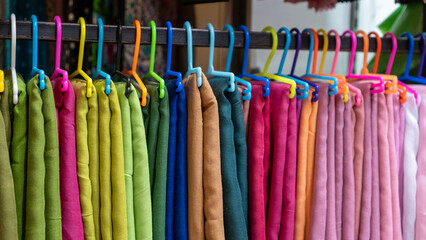 Colorful cloth display. Colorful hangers. Fabrics of various colors.