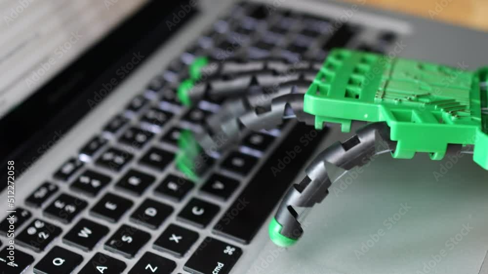 Aufkleber a robot hand using a laptop computer. the robotic ai artificial intelligence is typing on a keyboard